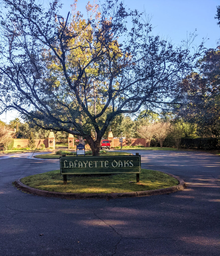 Picture of the Lafayette Oaks neighborhood sign under a tree